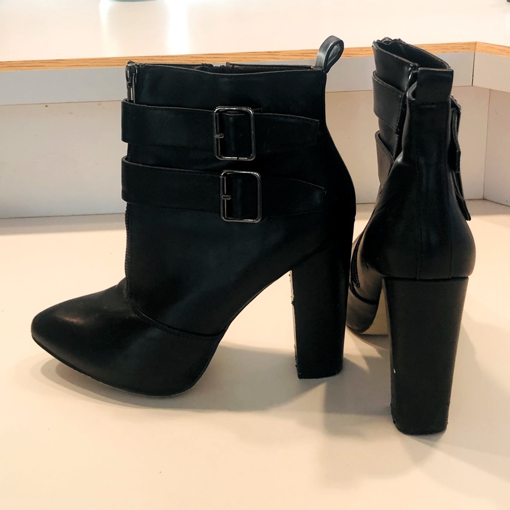 Black pointy toe high heel ankle booties with side strap details and a side zip